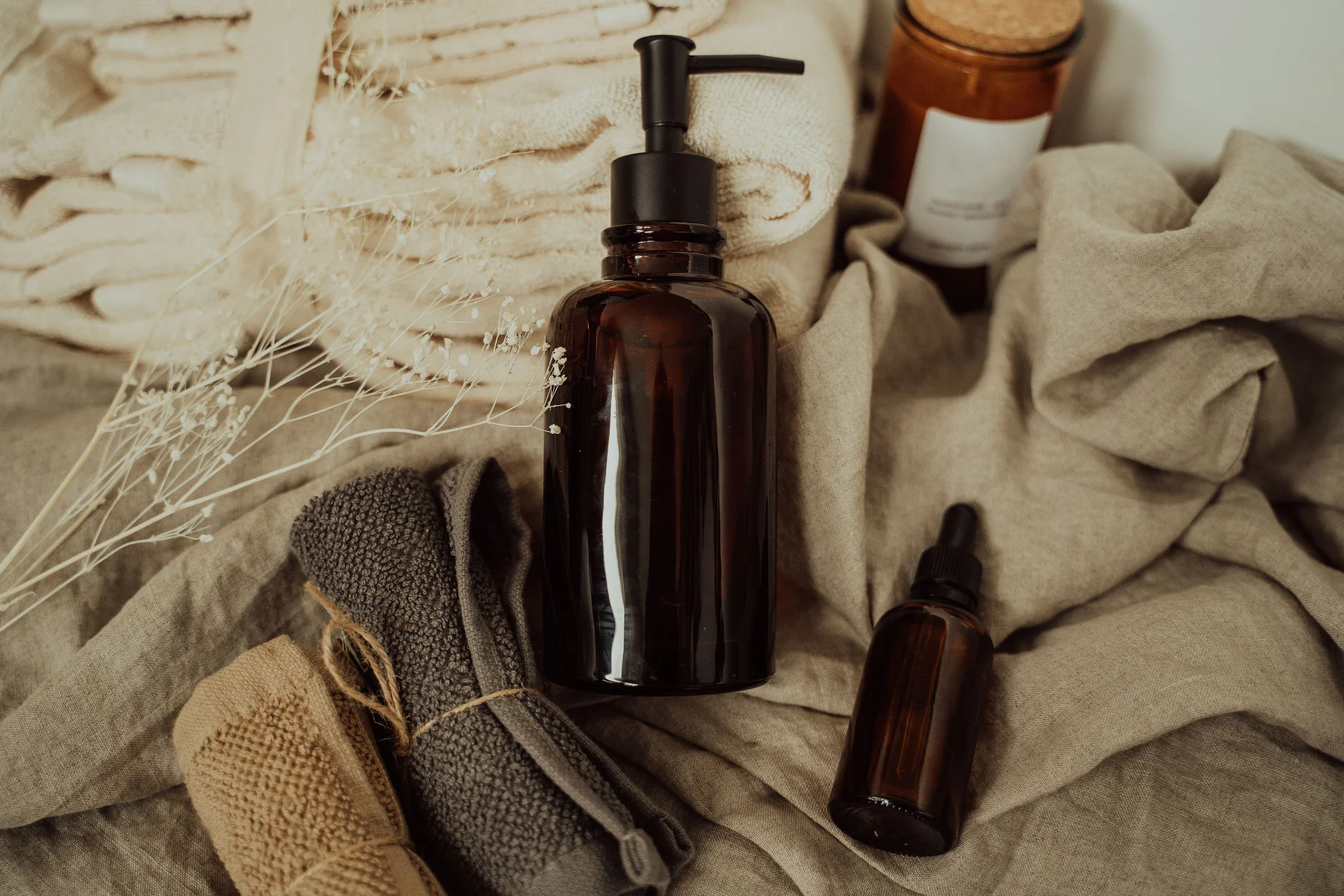 Stylish bathroom setup featuring amber bottles and soft towels for a spa-like experience.